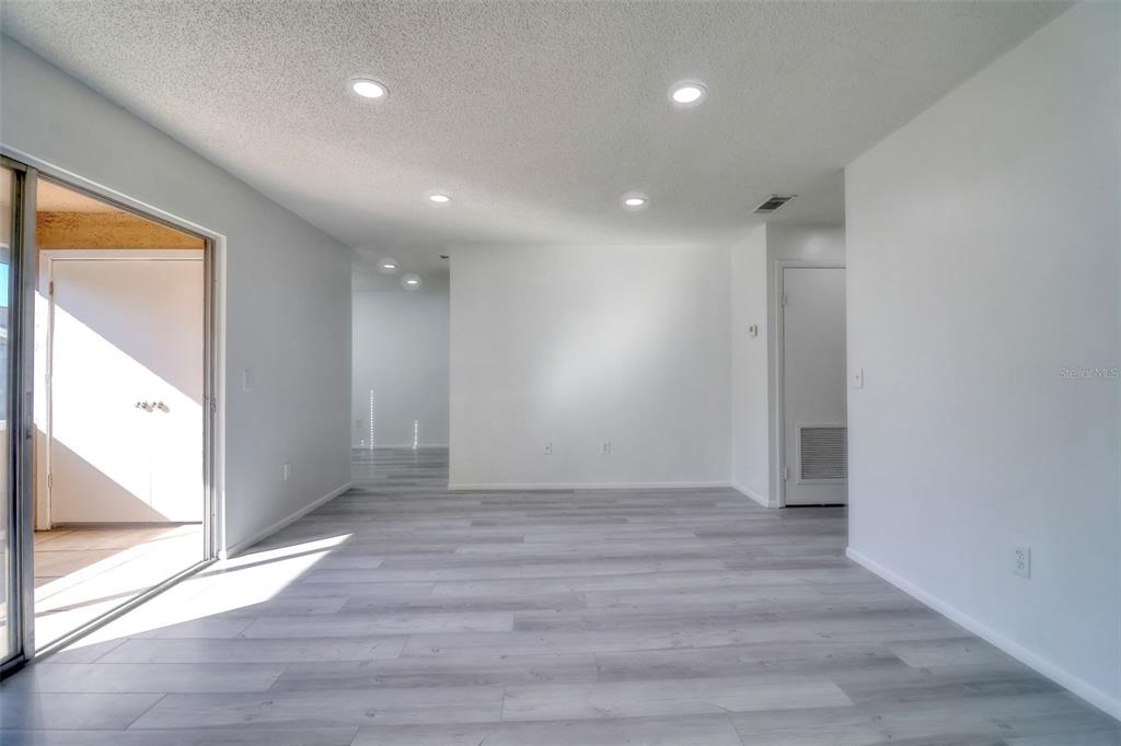 4004 Cortez Drive, Unit D Tampa, FL 33614 - Photo 4 of 30 an empty room with wooden floor and windows