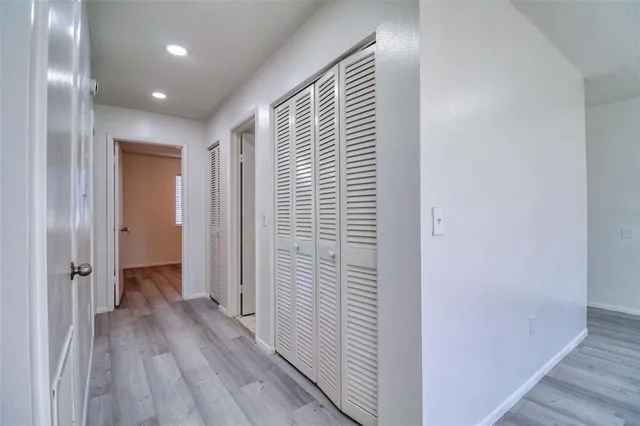 a view of a hallway with wooden floor