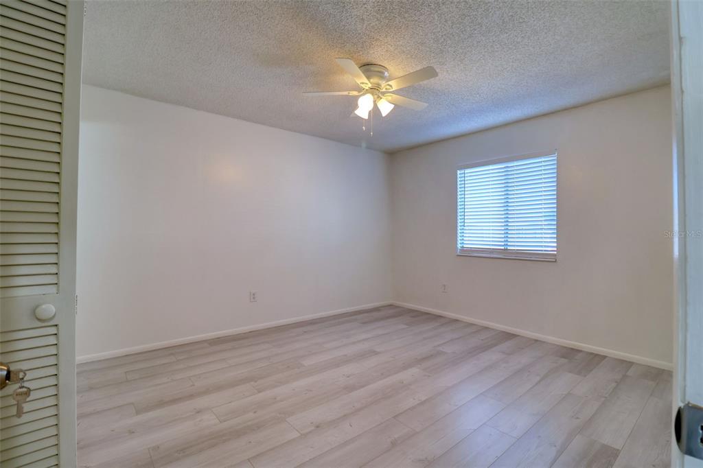 4004 Cortez Drive, Unit D Tampa, FL 33614 - Photo 8 of 30 a view of an empty room with wooden floor and a window