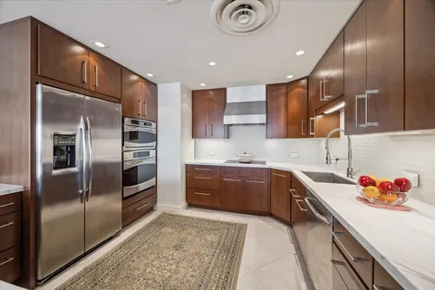 a kitchen with granite countertop stainless steel appliances and a sink