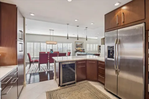a kitchen with stainless steel appliances granite countertop a refrigerator and a sink