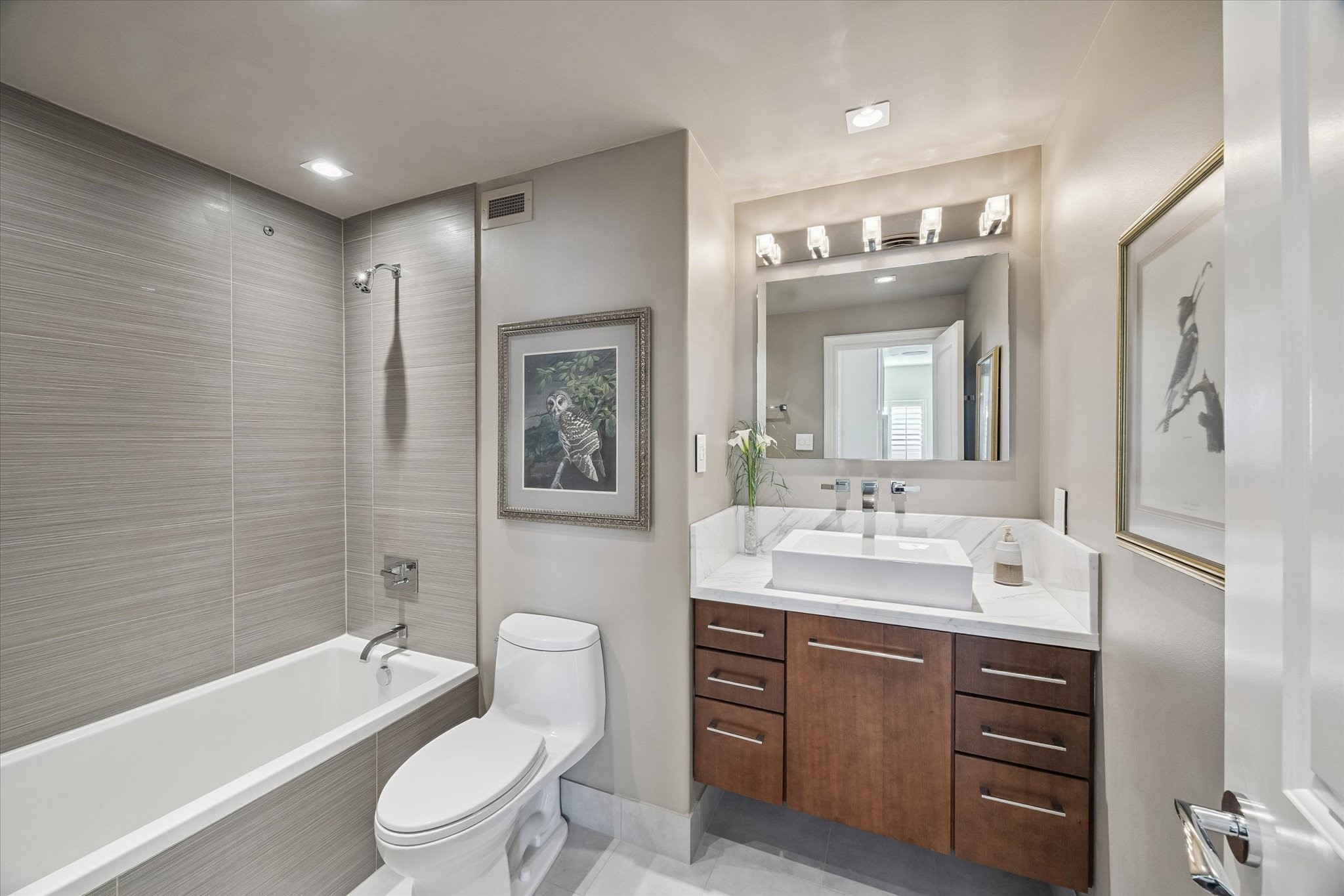 2929 Buffalo Speedway, Unit A1802 Houston, TX 77098 - Photo 16 of 50 a bathroom with a toilet a sink a tub and mirror