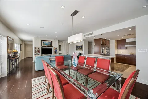 a living room with furniture kitchen view and a large window