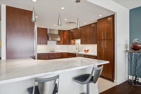 a kitchen with a table chairs refrigerator and microwave