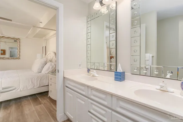 a bedroom with two beds and a large window