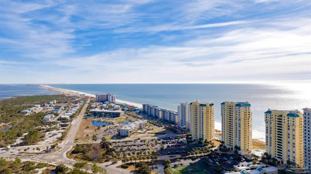 a front view of a house with a yard and potted plants