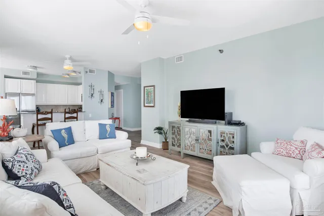 a living room with furniture a rug and a painting on the wall