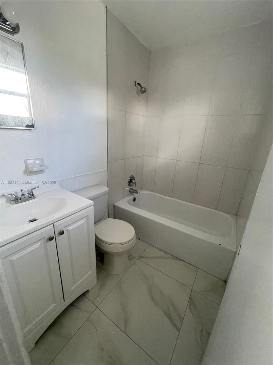 1102 South K Street, Unit 10 Lake Worth, FL 33460 - Photo 4 of 4 a bathroom with a sink a toilet and shower