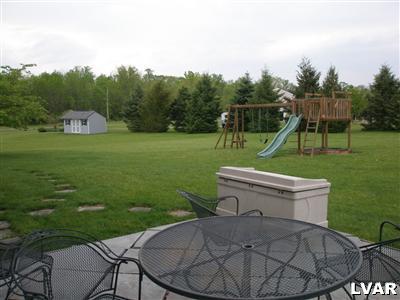 680 Clearfield Road Nazareth, PA 18064 - Photo 23 of 30 a view of a backyard with sitting area and slide