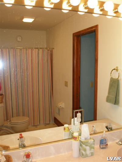 680 Clearfield Road Nazareth, PA 18064 - Photo 26 of 30 a bathroom with a granite countertop sink and a mirror