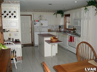 680 Clearfield Road Nazareth, PA 18064 - Photo 4 of 30 a kitchen with a sink a stove and chairs