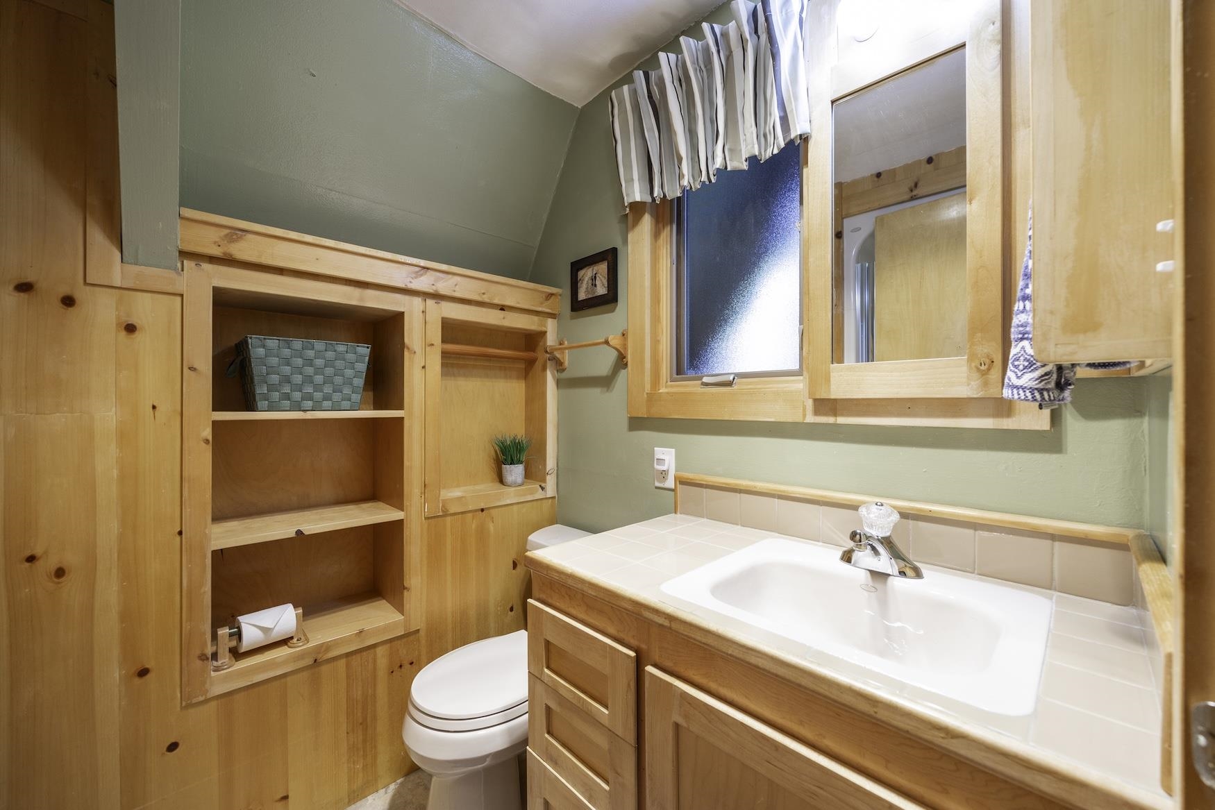 5262 Palisade Road Soda Springs, CA 95728 - Photo 13 of 24 a bathroom with a sink a toilet and a mirror