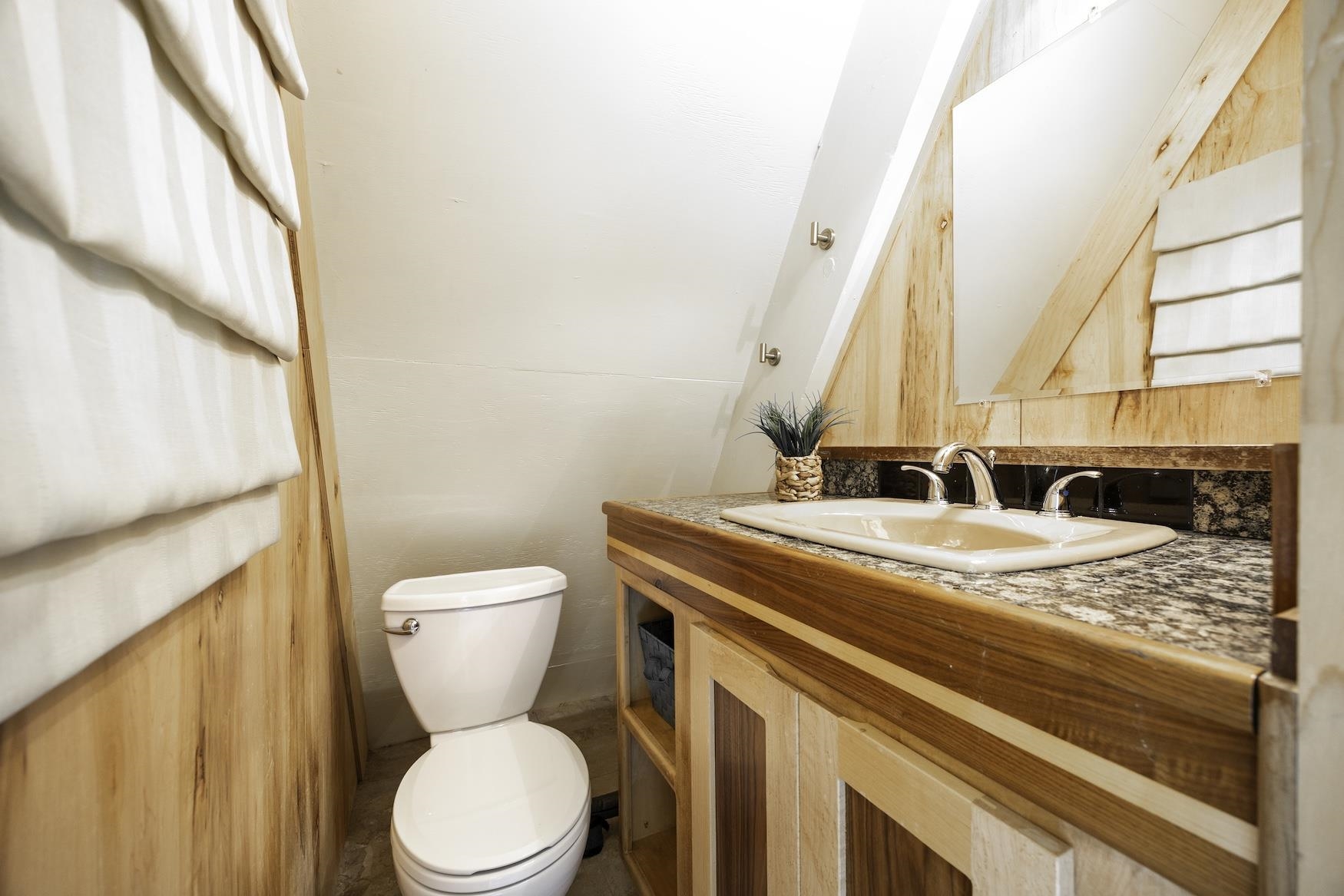 5262 Palisade Road Soda Springs, CA 95728 - Photo 16 of 24 a bathroom with a granite countertop toilet sink and mirror