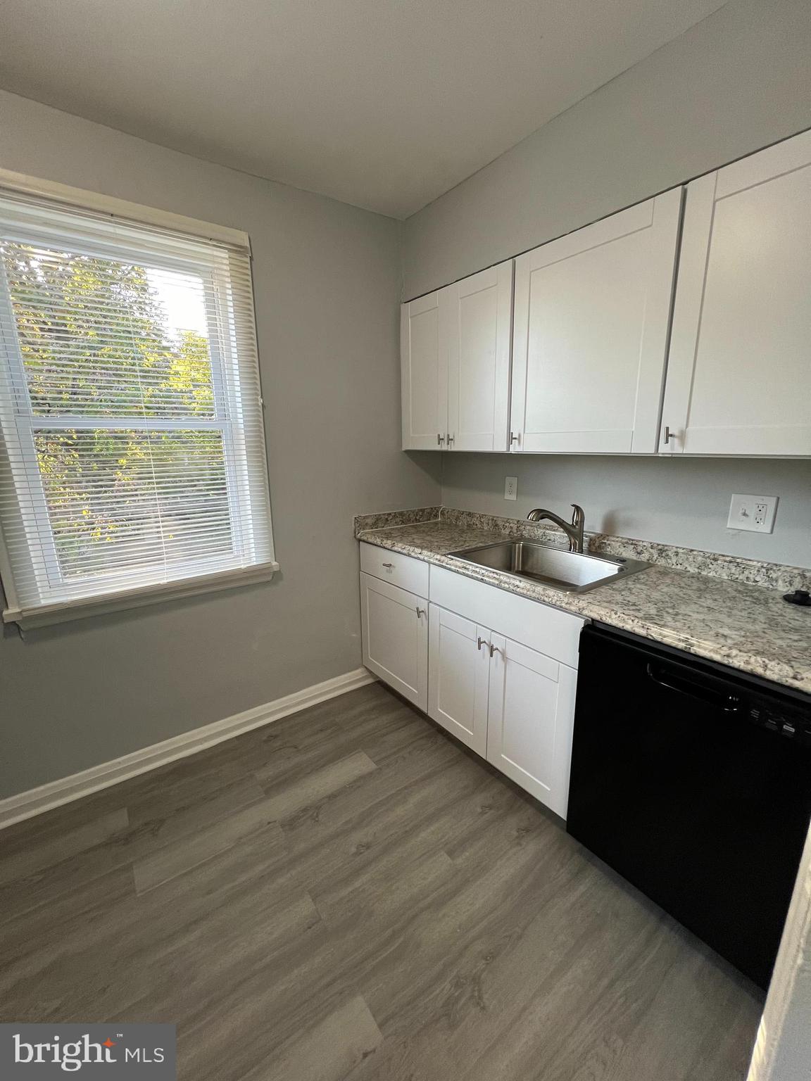 1100 Gleneagle Road Baltimore, MD 21239 - Photo 4 of 20 a kitchen with a sink a window and cabinets