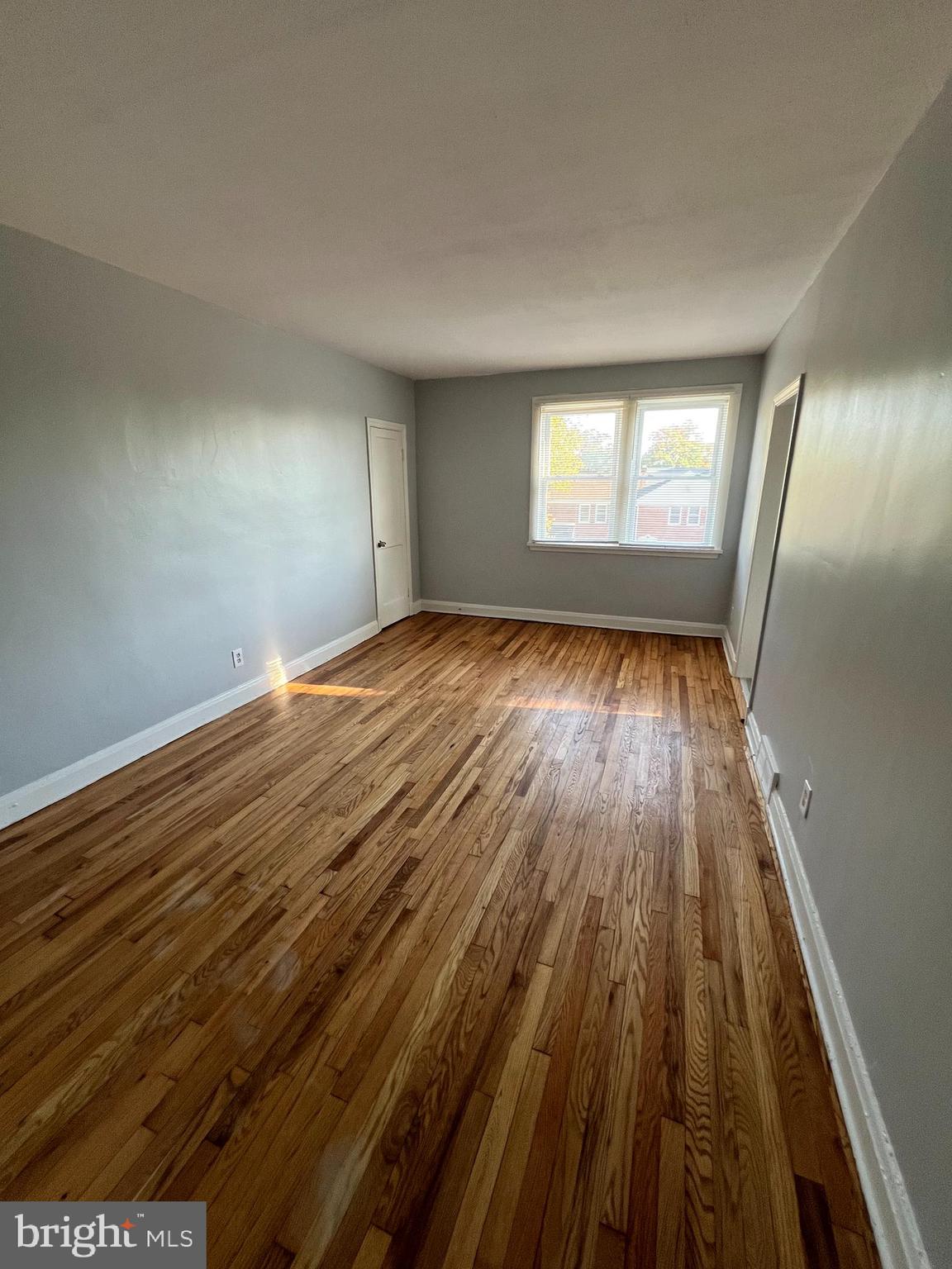 1100 Gleneagle Road Baltimore, MD 21239 - Photo 5 of 20 wooden floor in an empty room with a window
