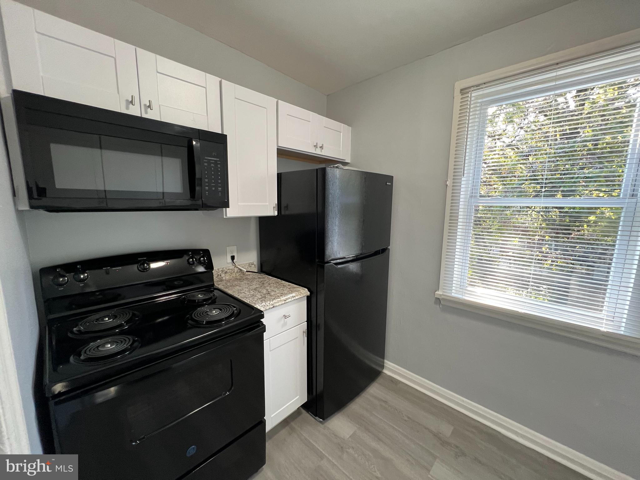 1100 Gleneagle Road Baltimore, MD 21239 - Photo 6 of 20 a kitchen with a refrigerator stove and microwave