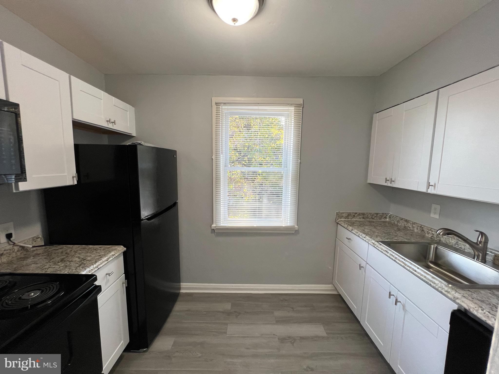 1100 Gleneagle Road Baltimore, MD 21239 - Photo 7 of 20 a kitchen with a refrigerator stove and sink