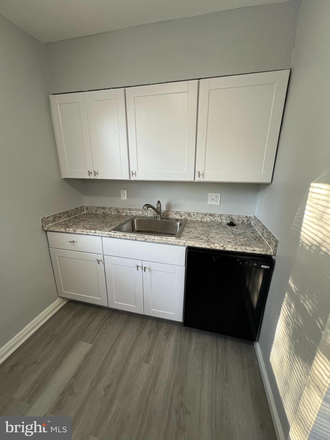 1100 Gleneagle Road Baltimore, MD 21239 - Photo 8 of 20 a kitchen with a sink a stove and cabinets