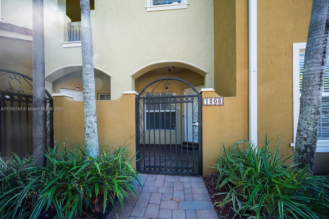 2851 Prospect Road, Unit 1208 Tamarac, FL 33309 - Photo 1 of 34 a front view of a house with a garden
