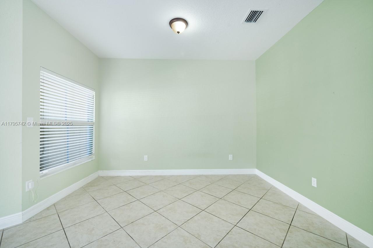 2851 Prospect Road, Unit 1208 Tamarac, FL 33309 - Photo 11 of 34 a view of an empty room with a window