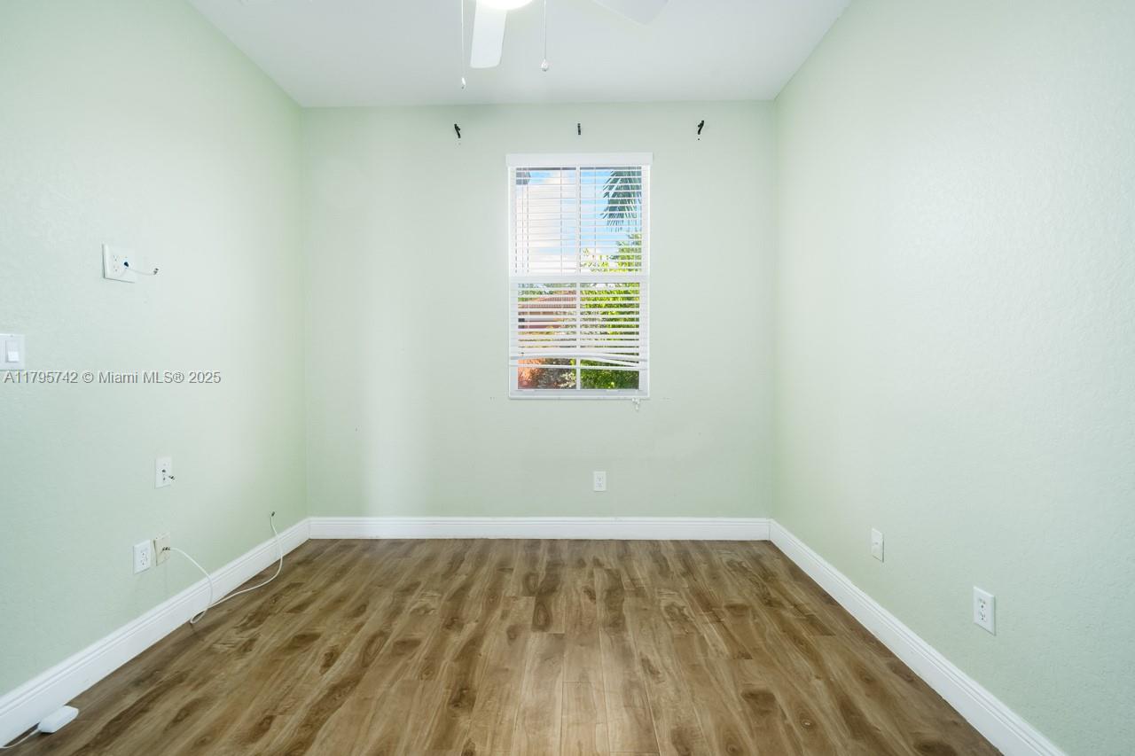 2851 Prospect Road, Unit 1208 Tamarac, FL 33309 - Photo 27 of 34 a view of a room with wooden floor and windows