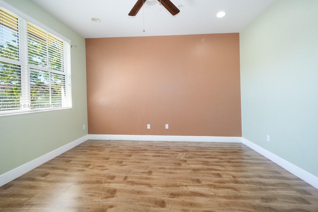 2851 Prospect Road, Unit 1208 Tamarac, FL 33309 - Photo 31 of 34 wooden floor in an empty room with a window