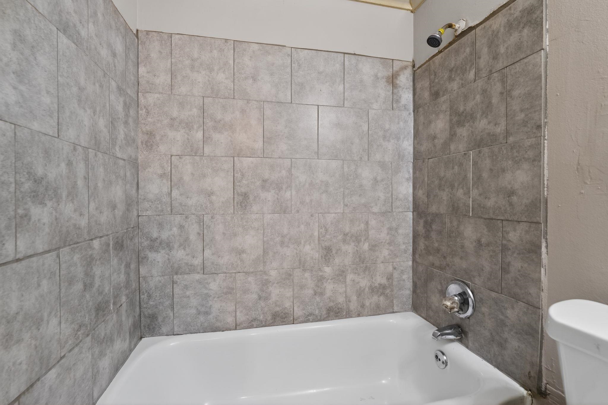 4504 Neely Road Memphis, TN 38109 - Photo 21 of 32 a bathroom with a bathtub and a shower