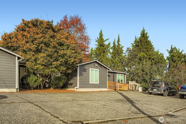 a view of a house with a tree in front of it
