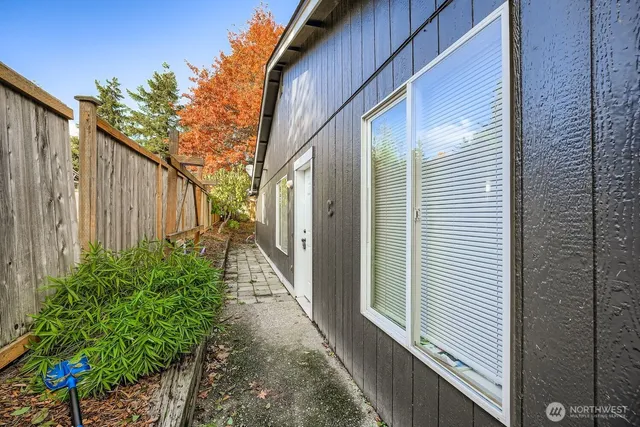 a path view of a house with a backyard