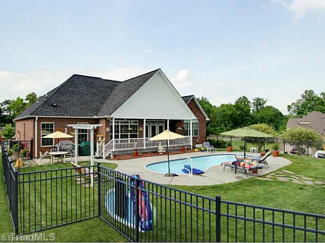 Exterior Back. Image relaxing by this fiberglass pool on a hot day! Perfect area for entertaining!