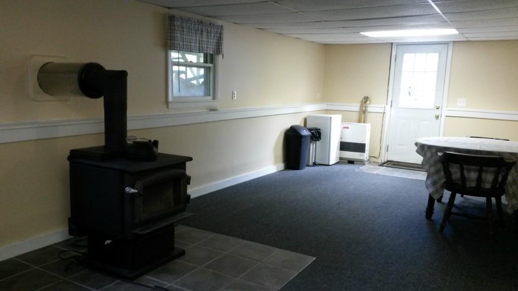 80 Winthrop Center Road Winthrop, ME 04364 - Photo 15 of 31 Family room with woodstove and door...