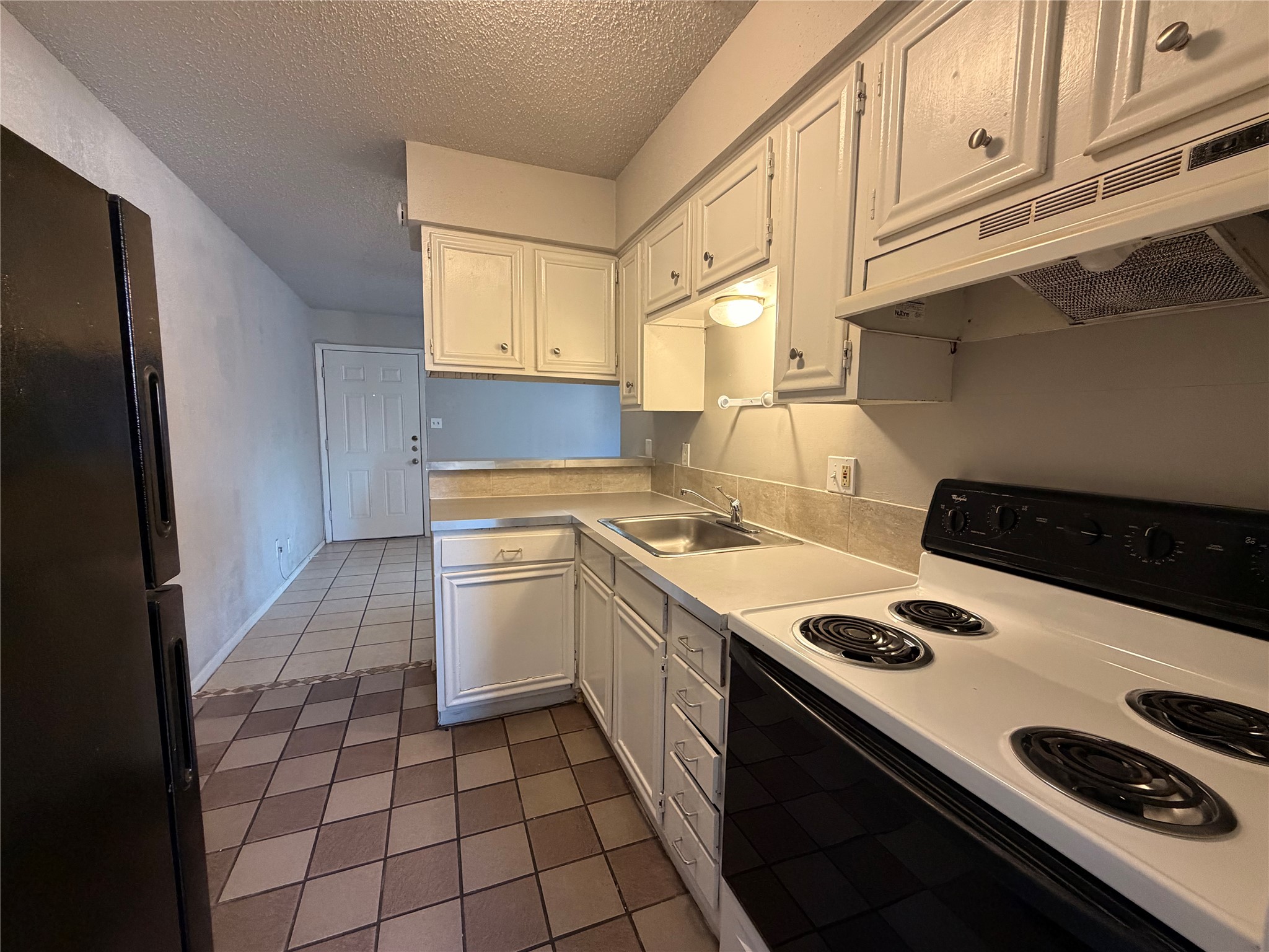 4303 Duval Street, Unit 204 Austin, TX 78751 - Photo 7 of 15 a kitchen with a stove a sink and a refrigerator