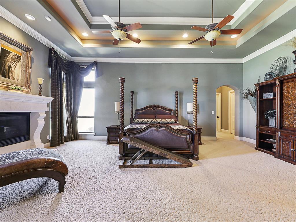1200 McReynolds Road Sanger, TX 76266 - Photo 12 of 40 a bedroom with a bed and a chandelier