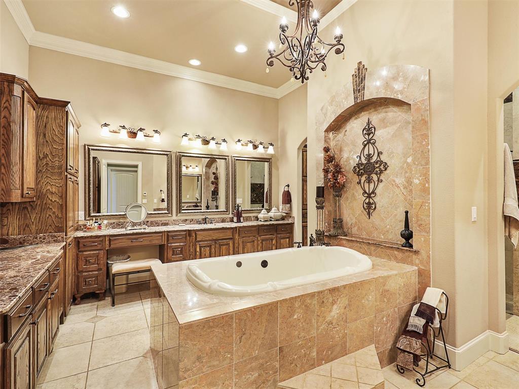 1200 McReynolds Road Sanger, TX 76266 - Photo 13 of 40 a spacious bathroom with a sink a large mirror and a bathtub
