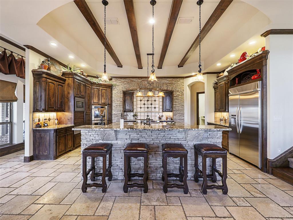 1200 McReynolds Road Sanger, TX 76266 - Photo 17 of 40 a dining hall with stainless steel appliances granite countertop a table chairs and granite counter tops