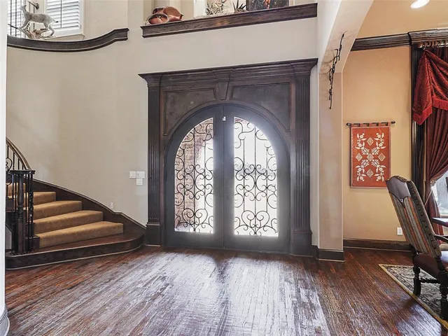a view of front door with wooden floor