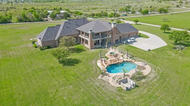 a view of a swimming pool with a yard