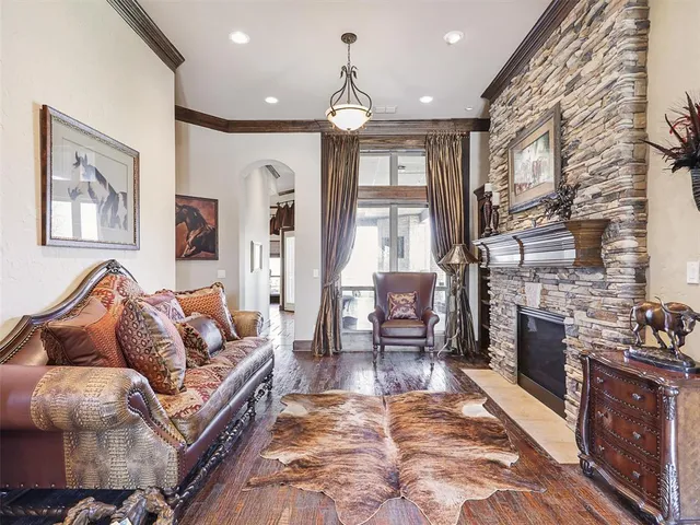 a living room with furniture a fireplace and a chandelier
