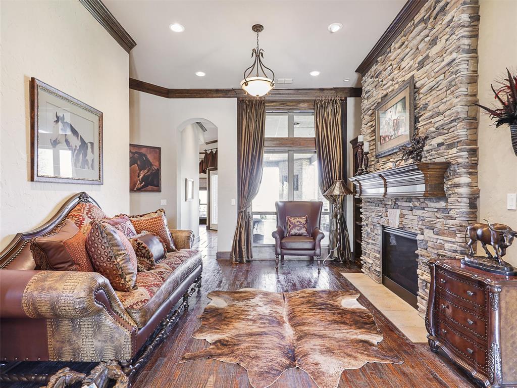1200 McReynolds Road Sanger, TX 76266 - Photo 7 of 40 a living room with furniture a fireplace and a chandelier