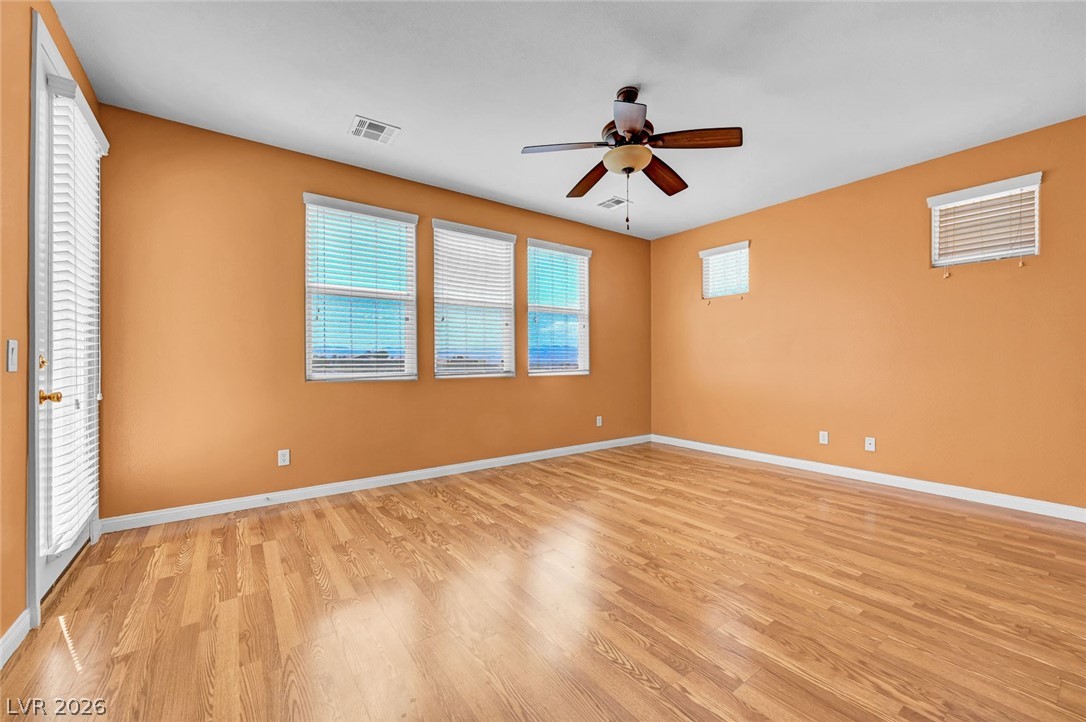 977 Sparkling Light Street Henderson, NV 89052 - Photo 42 of 75 This airy room features durable wood flooring and abundant natural light, perfect for comfortable living.