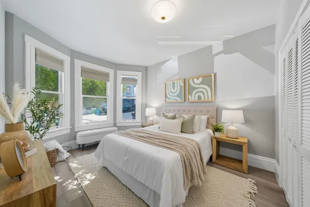 a bedroom with a bed and a couch