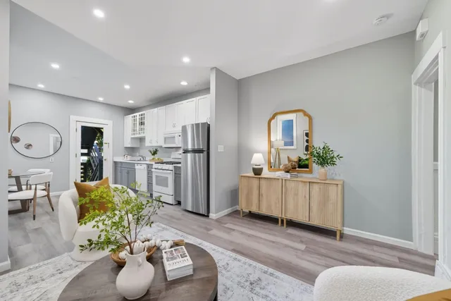 a living room with furniture and wooden floor