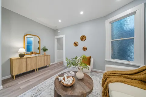 a kitchen with white cabinets stainless steel appliances and a window