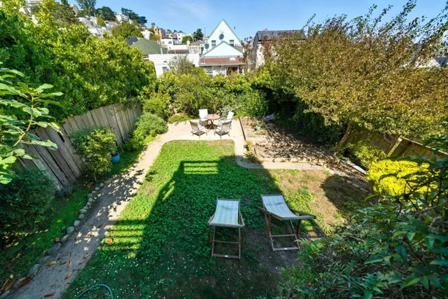 an aerial view of a house with a yard and lake view