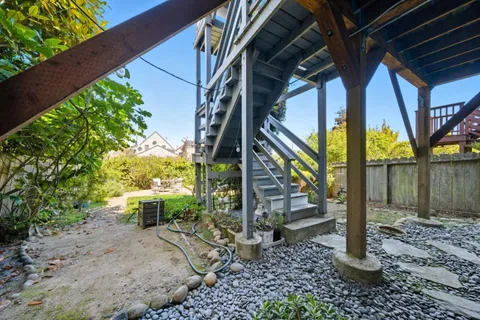 a view of a chairs and table in backyard