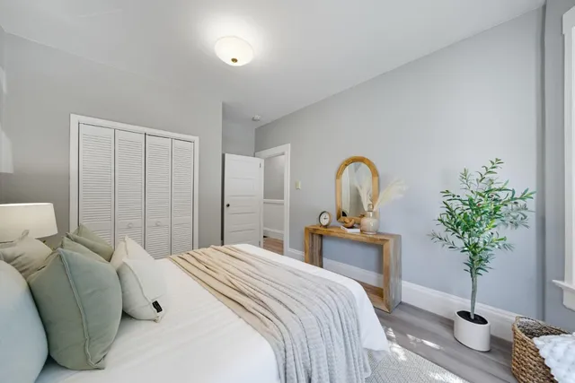 a bedroom with a bed and a potted plant