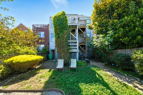 a front view of a house with chairs