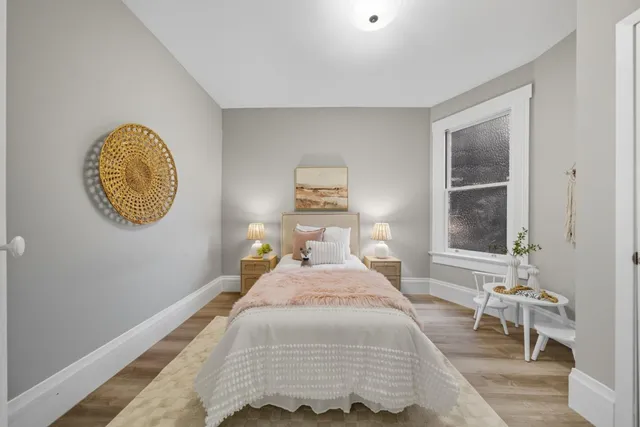 a bedroom with a bed and a window