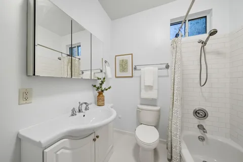 a bathroom with a bathtub and shower