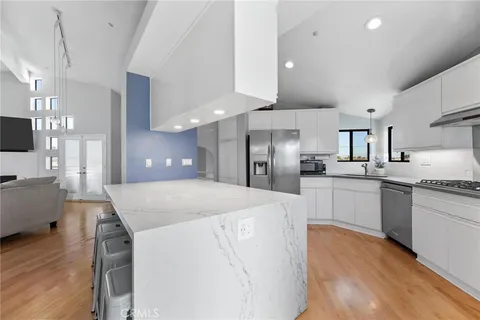 a kitchen with stainless steel appliances a refrigerator sink and stove